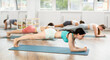 © JackF - Group of young girls performing plank exercise during Pilates class