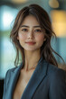 © Enrique - chinese businesswoman. An athletic chinese woman, 28 years old, muscular build, poised smile, looking slightly to the side, wearing a chic blazer, modern office background