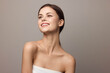 © SHOTPRIME STUDIO - Beautiful young woman in white dress posing for the camera on gray background