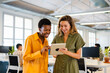 © Nuria Seguí/Stocksy - Businesswomen Using Digital Tablet In Modern Office