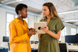 © Nuria Seguí/Stocksy - Businesswomen Using Digital Tablet In Modern Office