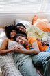 © BONNINSTUDIO/Stocksy - Female roommates embracing and holding hands on bed