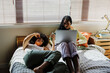 © BONNINSTUDIO/Stocksy - Female roommates relaxing on bed at morning