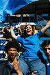 © BONNINSTUDIO/Stocksy - Excited female fan being carried by friends in stadium