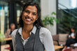 © Luis Velasco/Stocksy - Indian Woman Smiling At Camera At Work.