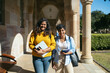 © Pedro Merino/Stocksy - Portrait Of Two Young University Students With Backpacks