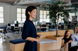 © BONNINSTUDIO/Stocksy - Smiling businesswoman leading brainstorming during meeting at office