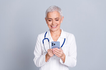 Sticker - Photo of charming professional doctor therapist woman wear white coat chatting patient isolated on grey color background