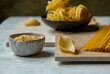 © Helen Rushbrook/Stocksy - Dried pasta including orzo and tagliatelle.