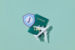© Marc Tran/Stocksy - Passport, Airplane, And Shield Icon Representing Travel And Safety
