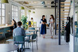 © BONNINSTUDIO/Stocksy - Managers walking and discussing in a modern coworking space