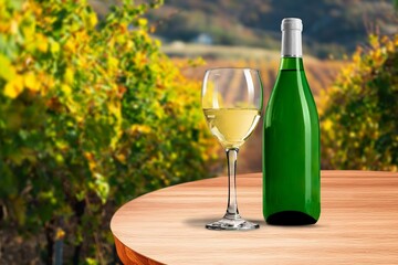 Sticker - Glass of white wine with green vineyards