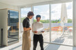 © Luis Velasco/Stocksy - Young Colleagues Reviewing Documents Near Windows