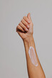 © BONNINSTUDIO/Stocksy - Woman applying moisturizer cream on her arm for skincare