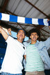 © BONNINSTUDIO/Stocksy - Male sports fans cheering with scarf at stadium