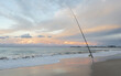 © Jodie Johnson Photography/Stocksy - Fishing rod at Currumbin beach, Gold Coast