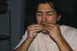 © Laura Herrera/Stocksy - Person eating lemon with sour face