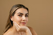 © ByLorena/Stocksy - Leaning on hand beauty portrait