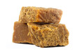 © manuelraw - pieces of artisanal sugar cane panela on an isolated white background