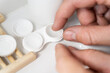 © Alba Vitta/Stocksy - Man putting on contact lenses
