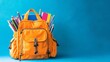 © NiK0StudeO - A bright orange school backpack filled with school supplies