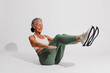 © BONNINSTUDIO/Stocksy - Senior woman doing crunches, maintaining fitness and healthy lifestyle