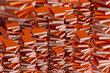 © Marcos Osorio/Stocksy - Background of stack of orange books