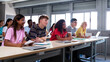 © Daniel - Panoramic image of multiracial happy, smiling college students in classroom listening to lecture.