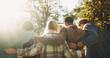 © AzeemudDeen/peopleimages.com - Group, back and friends to relax outdoor on school break, lens flare and hug for bonding in summer. People, students and embrace with support, care and trust together for social reunion at park