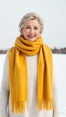 Wall Mural - older woman in yellow winter scarf on white plain background pictorial model shoot portrait 3