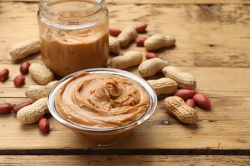 Poster - Tasty peanut butter and groundnuts on wooden table