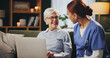 © peopleimages.com - Assisted living, laptop and senior woman with nurse on sofa in retirement home for medical advice or checkup. Computer, consulting and health with medical professional talking to elderly patient