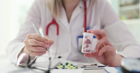 Sticker - Doctor holding bottle of pills writing prescription