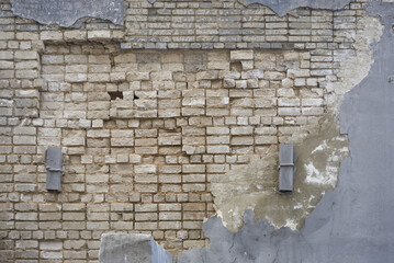 grey brick wall with old plaster