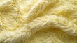© Caitlin - Soft and plush faux fur fabric in pale yellow and white hues, mimicking karakul lamb skin with a fleecy texture, warm and cozy appearance.