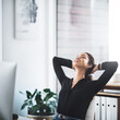 © Frank Coop/peopleimages.com - Woman, office and worker to relax at desk, stretching and human resources manager for peace. Female person, rest and professional for break in workplace, calm and mindfulness smile for self care