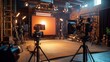 © Adisak - Professional film studio setup with multiple cameras and lighting equipment, ready for production. Ambient light fills the studio.