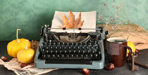 Wall Mural - Vintage typewriter, pumpkins, chestnuts, cup of coffee and autumn leaves on table