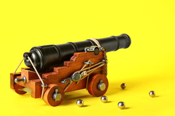 Toy model of cannon on yellow background