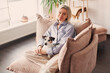 © Tatyana Gladskih - Cut Middle aged Woman sitting on couch at home