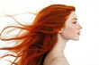© Artemiy - Profile portrait of a beautiful red-haired young woman with flowing hair on a white studio background.