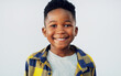 © ReeseArcurs/peopleimages.com - Portrait, smile and black child in studio for fashion, excited and summer fun. Young kid, happy and face on white background for positive energy, passport or junior school profile update in Nigeria
