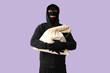 © Pixel-Shot - Male thief with bag on lilac background