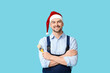 © Pixel-Shot - Portrait of male painter in Santa hat with brush on blue background