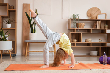 Poster - Cute little girl practising yoga at home