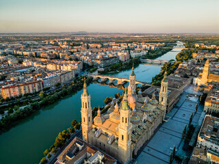 Spectacular Zaragoza city skyline at sunset. View of old town center, Cathedral of Zaragoza and Ebro River. Medieval and historic travel destination in Aragon - Spain. Sunset point, orange reflections