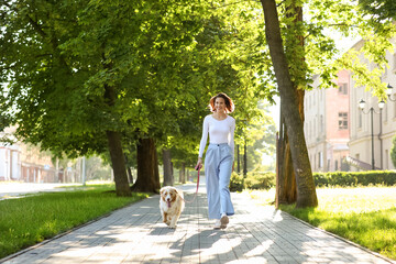 Sticker - Happy young woman with cute Australian Shepherd dog walking in park