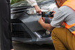© Jack Tamrong - Insurance agent man using smartphone taking pictures from car damage for evaluation claiming
