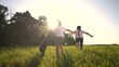 © maxximmm - children run in the meadow. happy family childhood dream concept. several children run on the grass in summer and have fun together. kids run in the meadow with green grass at sunset lifestyle