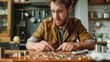 © A Denny Syahputra - A man sorts and counts various coins on a kitchen table, focused and deep in thought